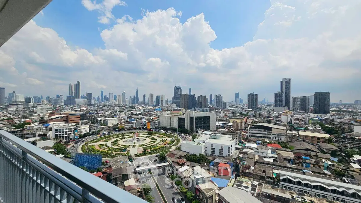 Stunning cityscape view from high-rise balcony overlooking urban skyline and vibrant city life.