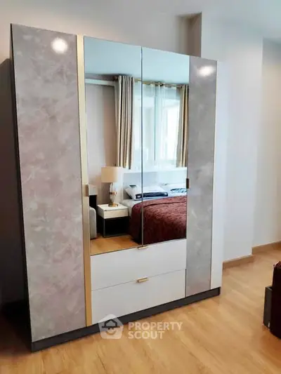 Modern bedroom with stylish mirrored wardrobe and cozy decor