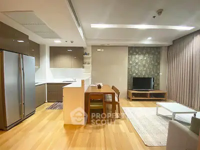 Modern open-layout kitchen and living room with sleek appliances and stylish decor.