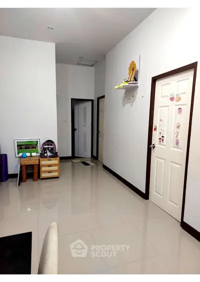 Spacious interior hallway with modern decor and glossy tiled flooring.