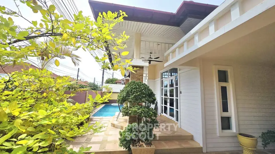 Charming modern home exterior with lush garden and inviting pool area