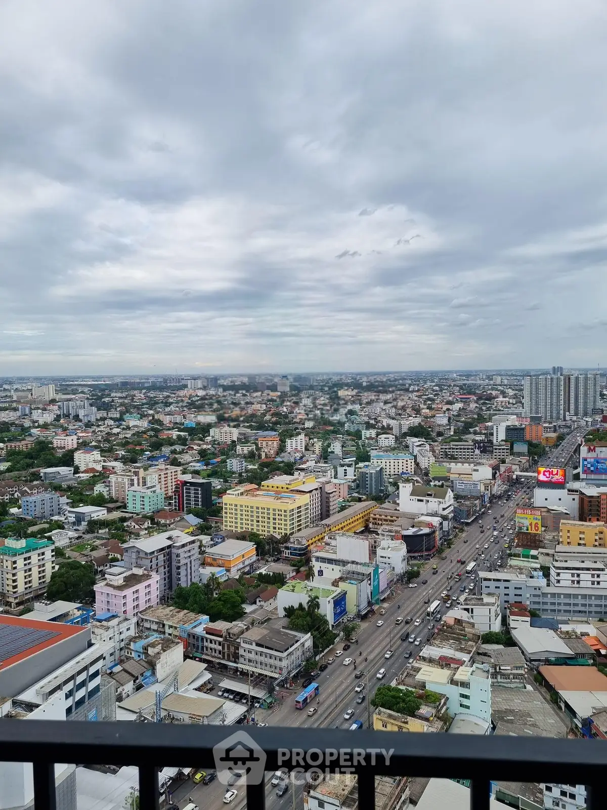 Stunning cityscape view from a high-rise balcony showcasing urban living and vibrant city life.
