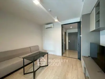 Modern living room with sleek furniture and air conditioning in a stylish apartment.