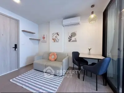 Modern living room with cozy sofa, stylish decor, and dining area in a contemporary apartment.