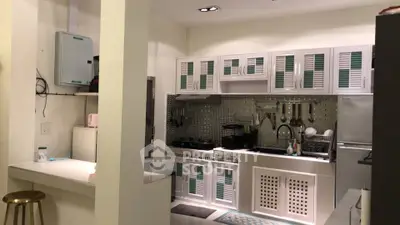 Modern kitchen with sleek cabinetry and stylish backsplash in a contemporary home.
