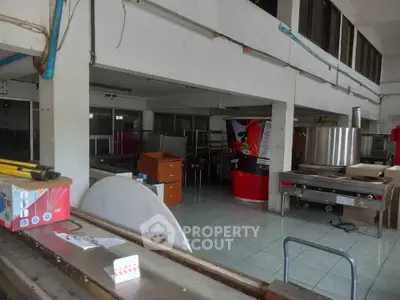 Spacious commercial kitchen space with industrial equipment and ample storage.