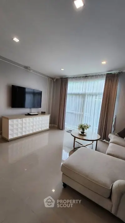 Modern living room with sleek TV setup and elegant furniture
