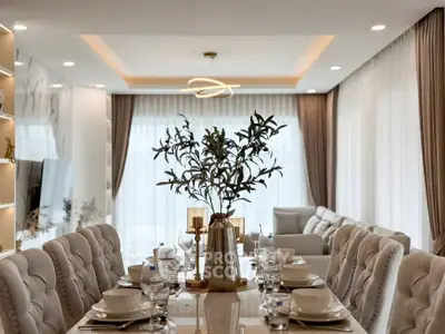 Luxurious open-plan living and dining area with elegant decor and natural light.