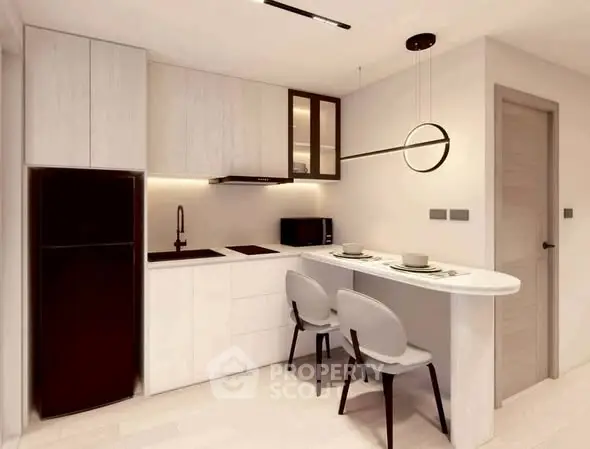 Modern kitchen with sleek design, featuring a breakfast bar and stylish lighting.