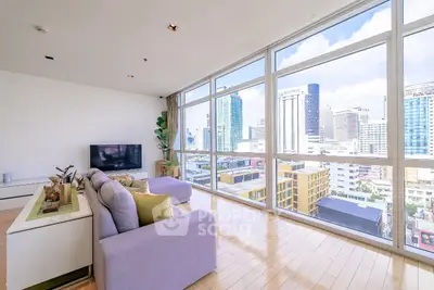 Spacious living room with panoramic city view and modern decor