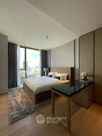 Luxurious bedroom with large window and elegant decor in modern apartment