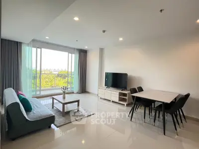Spacious modern living room with large window and stylish furniture