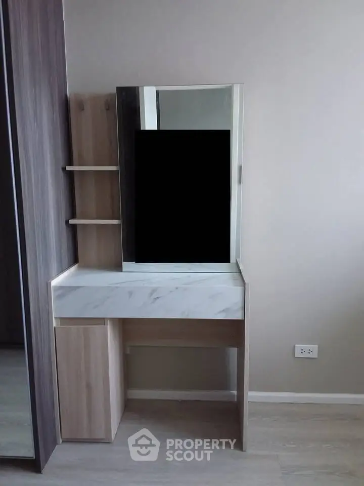 Modern bedroom with sleek vanity and built-in storage, perfect for stylish living.