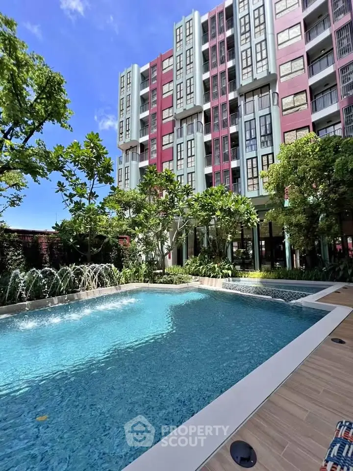 Luxurious residential building with stunning pool and lush greenery