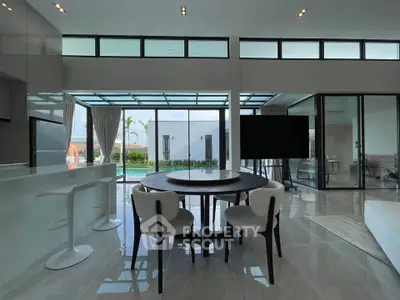 Luxurious modern living room with pool view and elegant furnishings