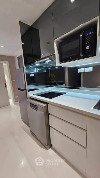 Modern kitchen with sleek appliances and glossy cabinetry