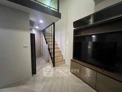 Modern loft apartment with sleek staircase and stylish entertainment unit