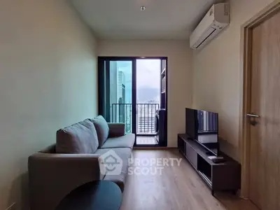 Modern living room with balcony view in a high-rise apartment