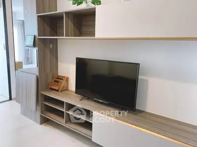 Modern living room with sleek wooden TV stand and wall-mounted shelves