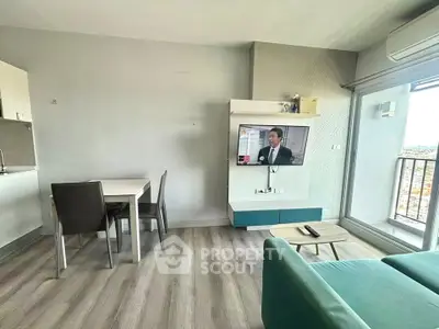 Modern living room with dining area and balcony view in a stylish apartment.