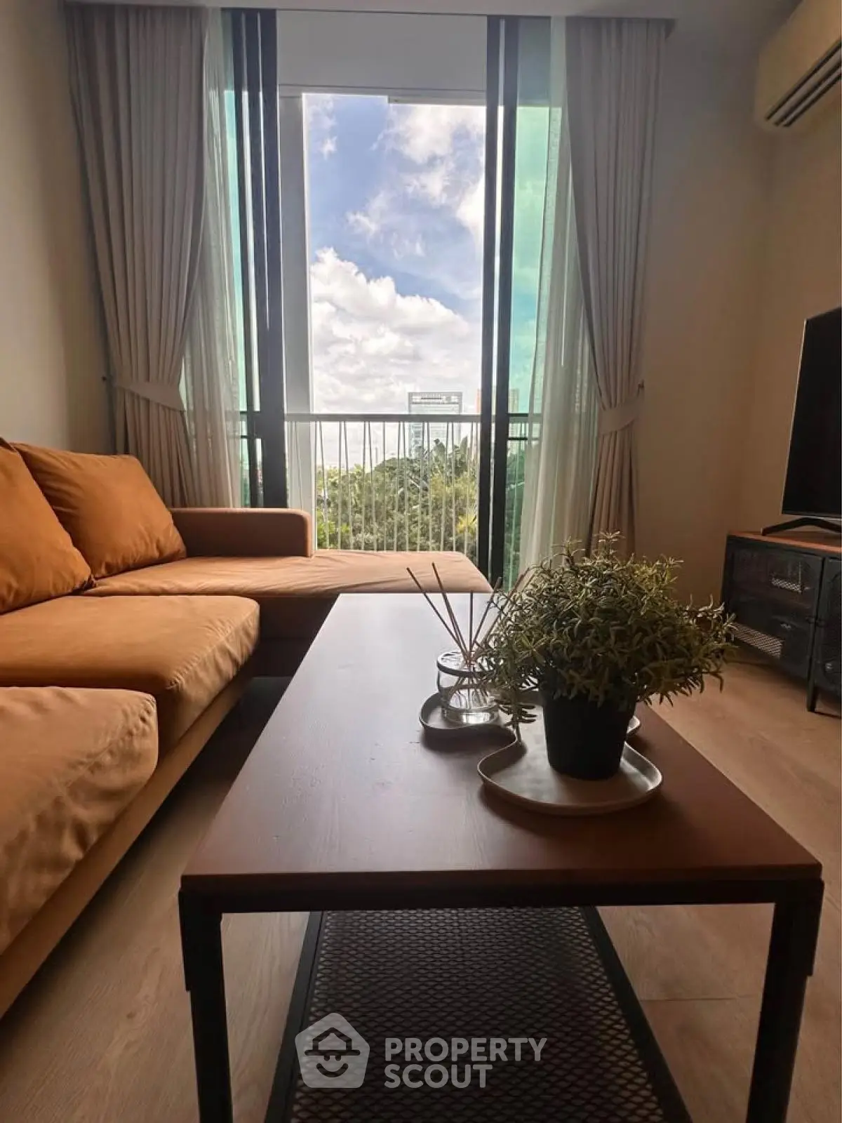 Stylish living room with cozy sofa and scenic balcony view