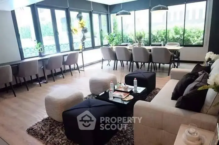 Spacious modern living room with large windows and elegant dining area, perfect for entertaining.