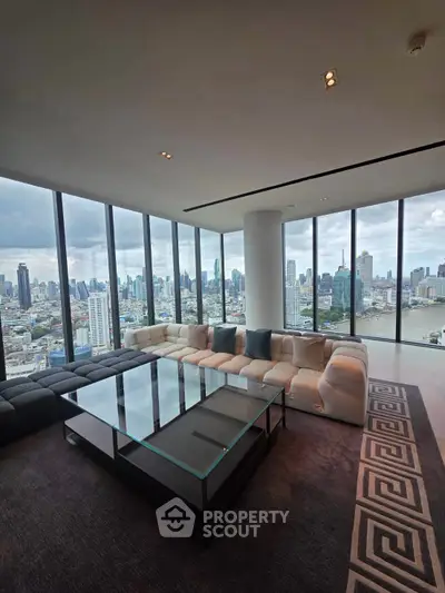 Luxurious corner unit living room with panoramic city views and modern furnishings.