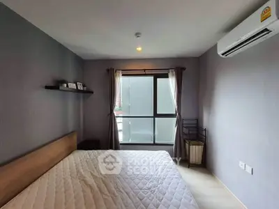 Modern bedroom with large window and air conditioning in a stylish apartment.