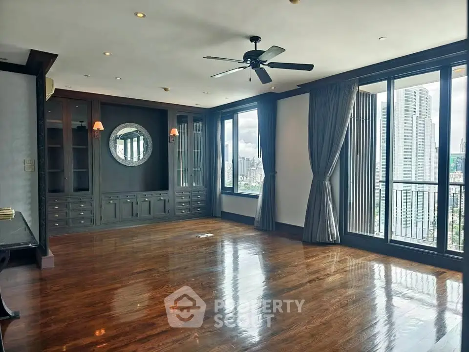 Spacious living room with hardwood floors and city view in luxury apartment
