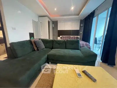 Modern living room with green sectional sofa and cozy ambiance