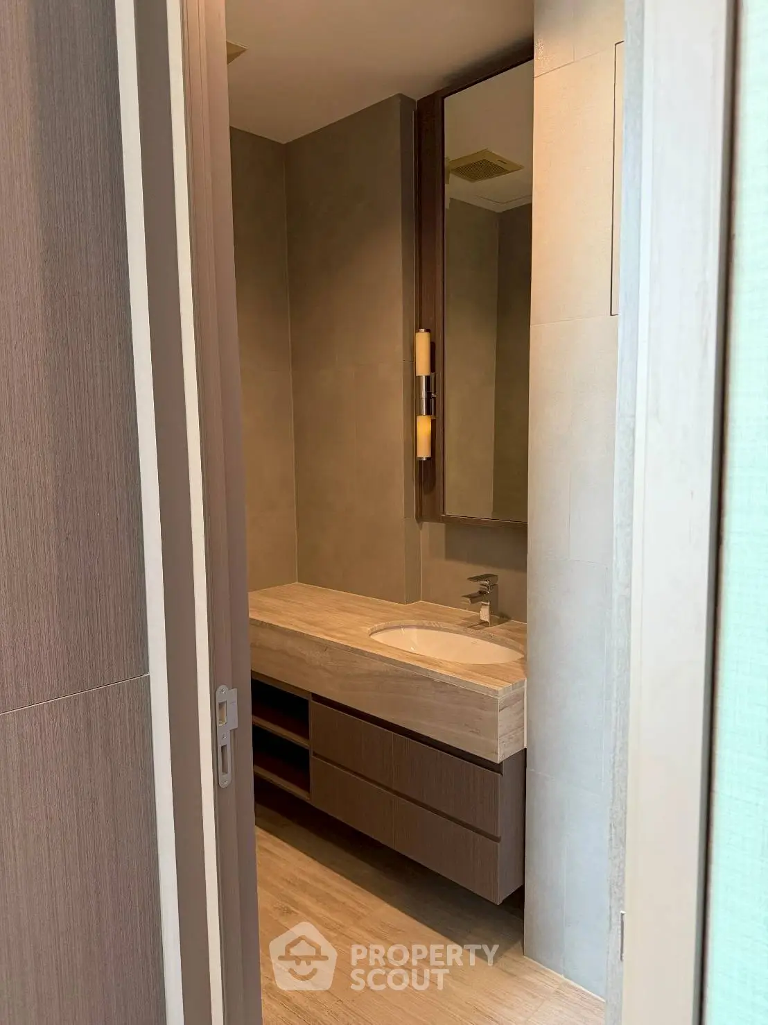 Modern bathroom with sleek wooden cabinetry and elegant lighting