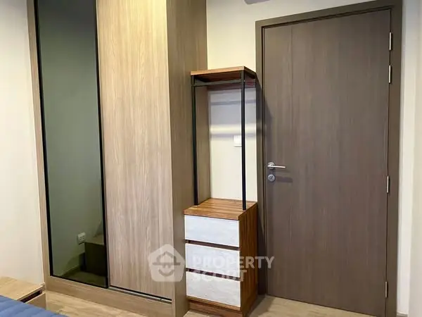 Modern bedroom with sleek wooden wardrobe and stylish door
