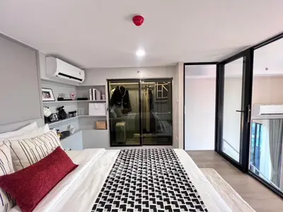 Modern bedroom with stylish decor and walk-in closet in luxury apartment
