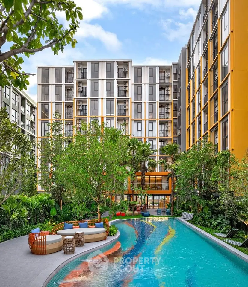 Modern apartment complex with vibrant pool and lush greenery