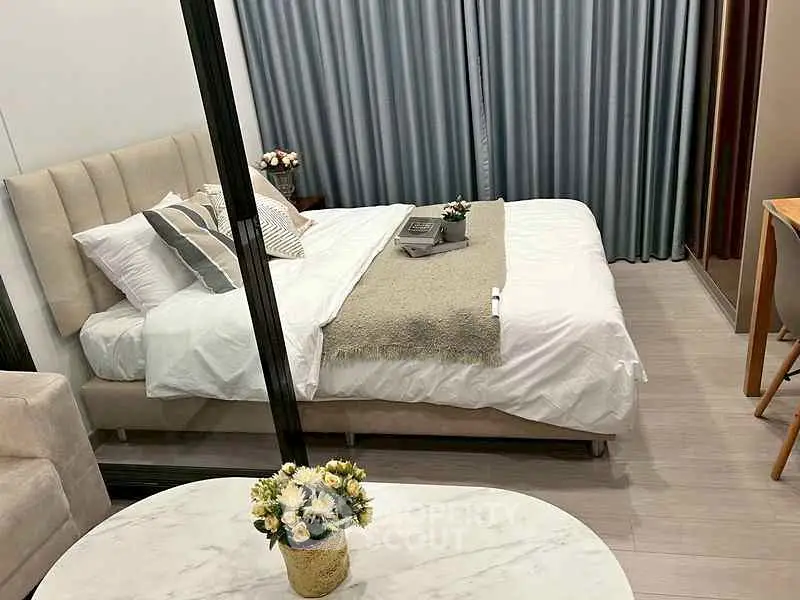 Elegant bedroom with cozy bed and modern decor in a stylish apartment.