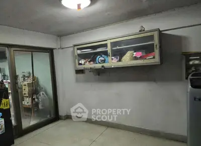 Spacious storage room with sliding glass doors and wall-mounted cabinet.