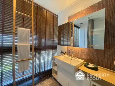 Luxurious bathroom with modern sink and stylish blinds