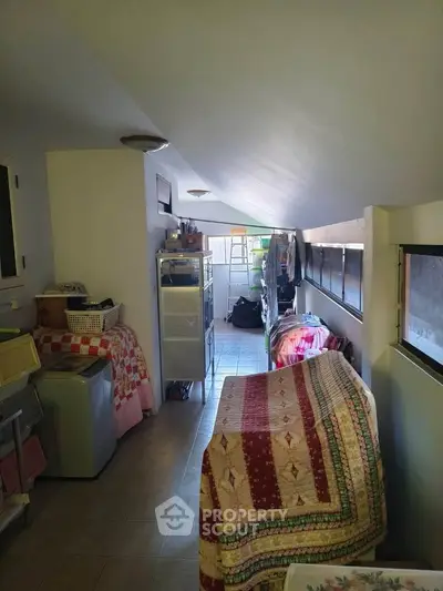Cozy attic storage space with sloped ceiling and organized shelves.