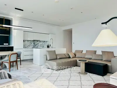 Luxurious open-plan living room with modern kitchen and elegant furnishings