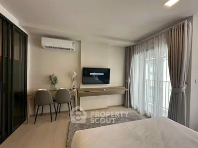 Modern bedroom with study area and large window for natural light