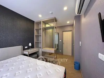 Modern bedroom with stylish decor and built-in closet in a contemporary apartment.