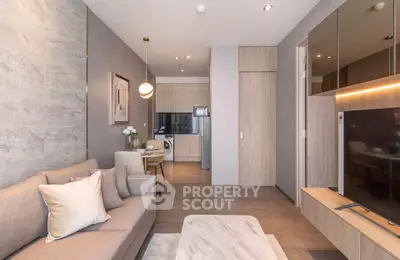 Modern living room with open kitchen, stylish decor, and cozy ambiance in a contemporary apartment.
