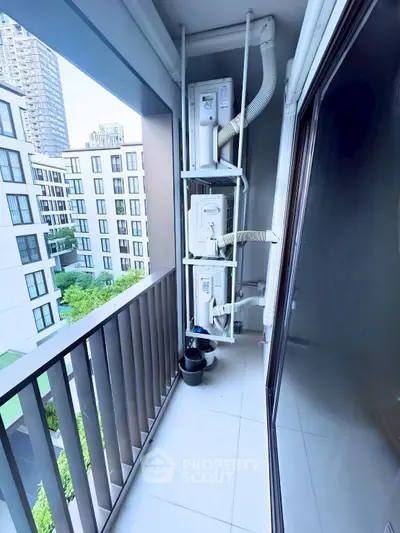 Modern apartment balcony with city view and air conditioning units