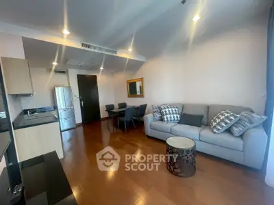 Modern living room with stylish decor and open layout, featuring a cozy sofa and dining area.