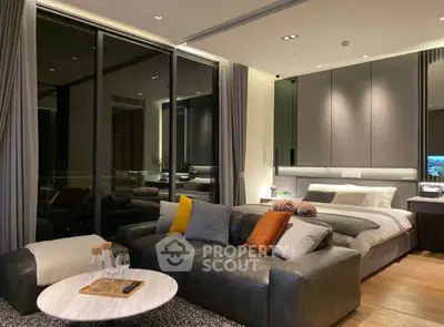Luxurious modern bedroom with stylish decor and cozy seating area.