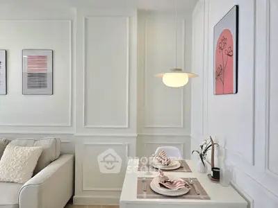 Chic modern living room with elegant dining setup and stylish wall art