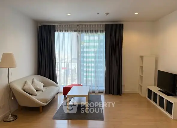 Spacious modern living room with large window and stylish furniture