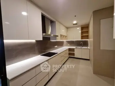 Modern kitchen with sleek cabinetry and integrated appliances in a contemporary apartment.