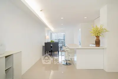 Spacious modern living area with sleek kitchen and dining space, perfect for entertaining.