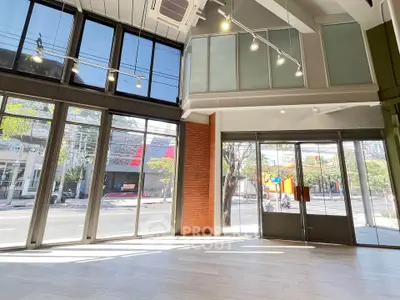 Spacious commercial space with large windows and high ceilings for lease.